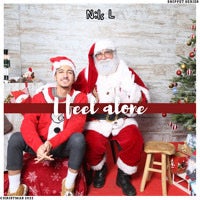 a man and a santa claus posing in front of a christmas tree