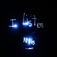 the words i listen nls are written on a dark wall